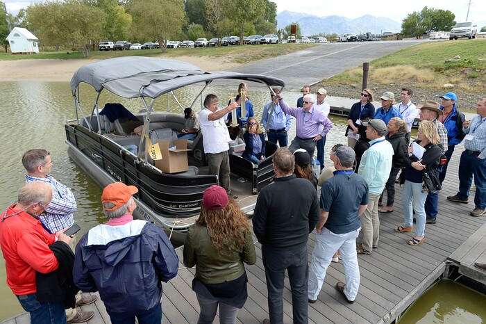 (Francisco Kjolseth | The Salt Lake Tribune) Theron Miller of the Wasatch Front Water Quality Council shows the difference seen in samples of Utah Lake water after treating one with Aluminum Sulfate that has been shown to treat against elevated phosphorus and algae blooms. Members of the Legislative Water Development Commission gathered before a tour of Utah Lake on Wednesday, Sept. 13, 2017, for the purpose of learning of wastewater treatment, the importance of protecting our lakes and rivers, how the state is looking to change water quality standards and how regulation is an important local issue.