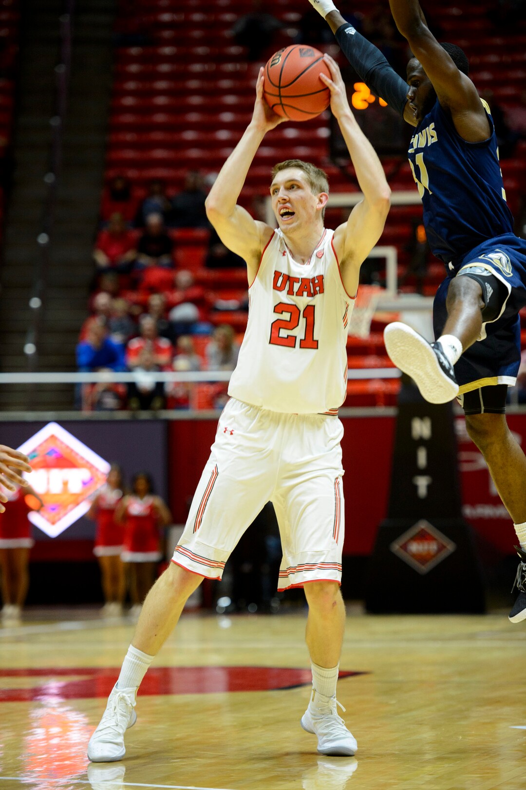 (Steve Griffin  |  The Salt Lake Tribune)  Utah Utes forward Tyler Rawson (21) fakes UC Davis Aggies guard Michael Onyebalu (31) into the air during the Utah versus UC Davis men's NIT basketball game at the Huntsman Center in Salt Lake City Wednesday March 14, 2018.