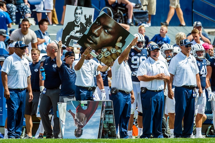 (Chris Detrick  |  The Salt Lake Tribune)  Brigham Young Cougars hold up signs of Michael Jordan and Ty Detmer during the game at LaVell Edwards Stadium Saturday, August 26, 2017.