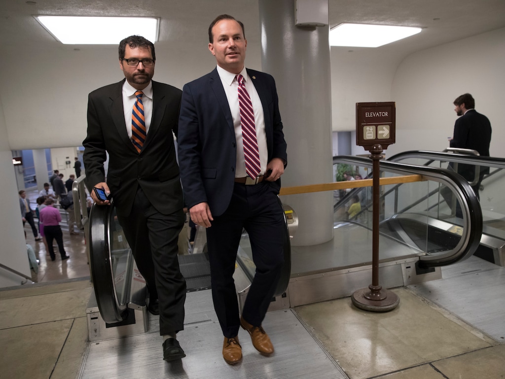Sen. Mike Lee, R-Utah, and his communications director, Conn Carroll, head to the chamber for a vote, on Capitol Hill in Washington, Thursday, July 20, 2017. Carroll is tweeting up a storm of skepticism about the sexual misconduct accusations against Brett Kavanaugh while Lee is remaining silent.  (AP Photo/J. Scott Applewhite)