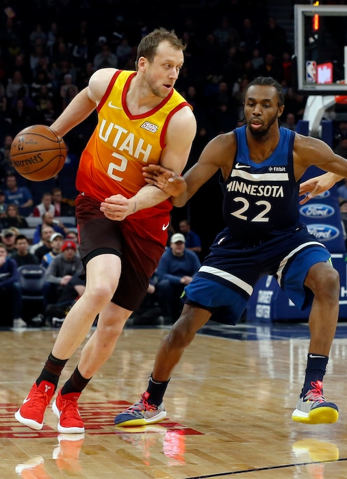 Utah Jazz's Joe Ingles, left, of Australia drives around Minnesota Timberwolves' Andrew Wiggins in the first half of an NBA basketball game Sunday, Jan. 27, 2019, in Minneapolis. (AP Photo/Jim Mone)