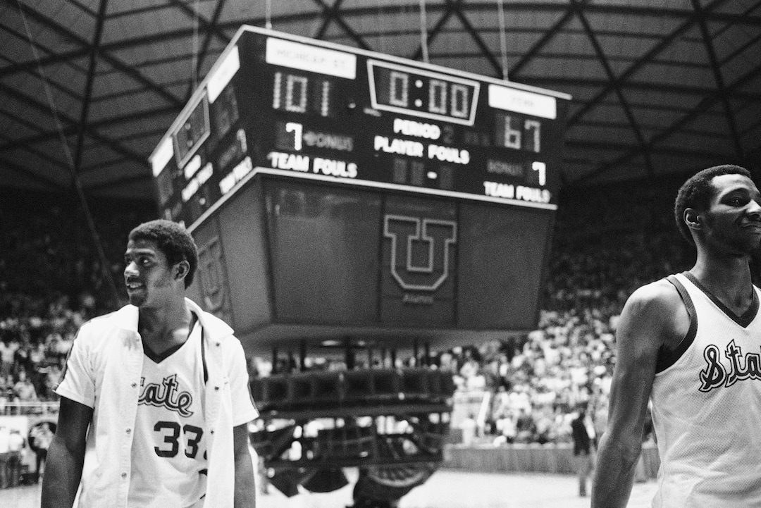 (AP Photo) Michigan State stars Earvin Johnson (33) and Gregory Kelser (32) are all smiles and the scoreboard tells why, Saturday, March 24, 1979 in Salt Lake City after their team defeated Pennsylvania 101-67 to advance to the finals of the NCAA Championships. 