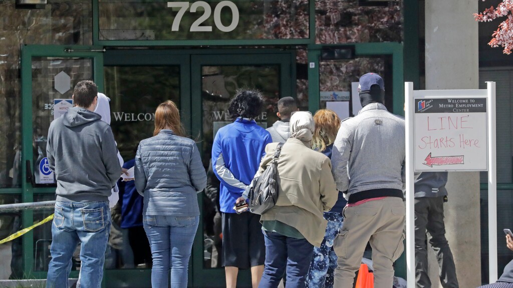 (Rick Bowmer | AP) In this April 13, 2020, file photo, people line up outside the Utah Department of Workforce Services in Salt Lake City. Unemployment claims in Utah are settling into levels that are much lower than the pandemic peak in early April but remain historically high, new figures released Thursday, June 18, 2020, show.