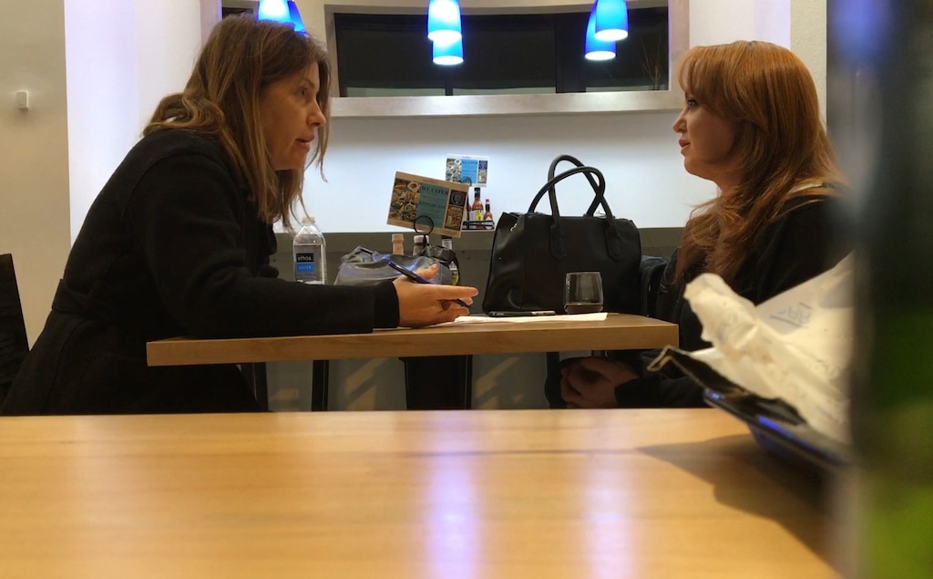 Washington Post reporter Stephanie McCrummen, left, interviews Jaime T. Phillips at a Greek restaurant in Alexandria, Va., on Wednesday. (Dalton Bennett/ The Washington Post)