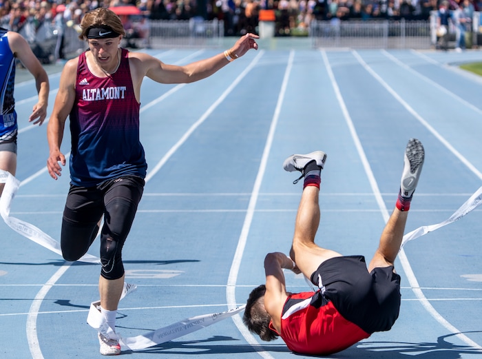 (Rick Egan | The Salt Lake Tribune)  Altamont's Ethan Hansen finishes in second place as Blake Barnes dives headfirst into the finish line for a first place finish in the 1A Boys 200 meter dash, at the State High School Championships at BYU, on Saturday, May 21, 2022.
