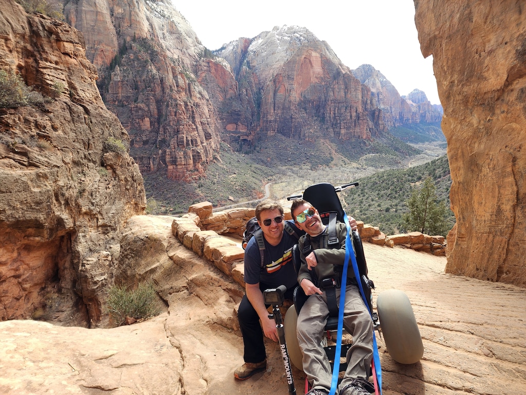(Extreme Motus) Ryan Grassley pushing Sam Durst, who was born with Cerebal Palsy, in an Extreme Motus wheelchair in Zion National Park. The park now offers the all-terrain wheelchair to visitors.