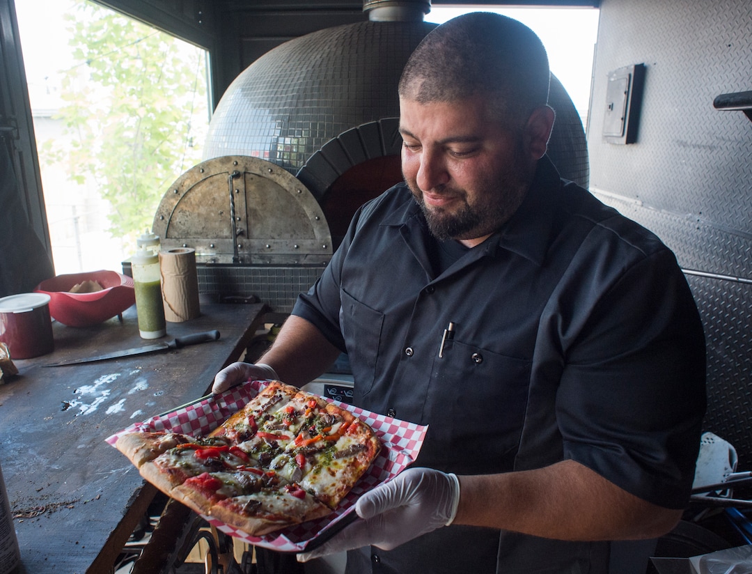 (Rick Egan  |  The Salt Lake Tribune)  Fabio Marsenro prepares the Criolla pizza with smoked beef brisket, red peppers with homemade chimichurri in the Umani food truck.