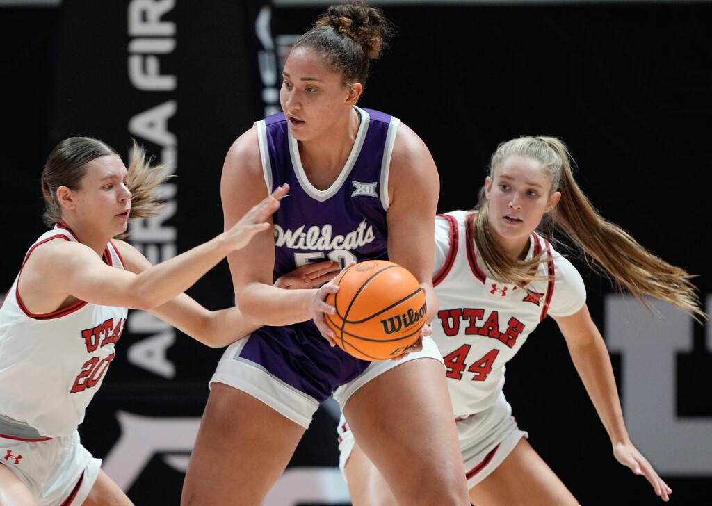 (Francisco Kjolseth | The Salt Lake Tribune) Kansas State Wildcats center Ayoka Lee (50) keeps the ball away from Utah Utes forward Reese Ross (20) and Utah Utes forward Samantha Crispe (44) as Utah hosts Kansas State, NCAA basketball in Salt Lake City on Wednesday, Jan. 8, 2025.