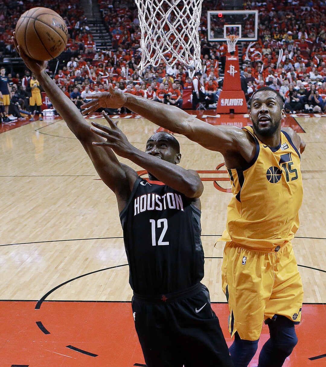 Houston Rockets forward Luc Mbah a Moute (12) drives to the basket as Utah Jazz forward Derrick Favors defends during the second half in Game 1 of an NBA basketball second-round playoff series, Sunday, April 29, 2018, in Houston. Houston won 110-96. (AP Photo/Eric Christian Smith)
