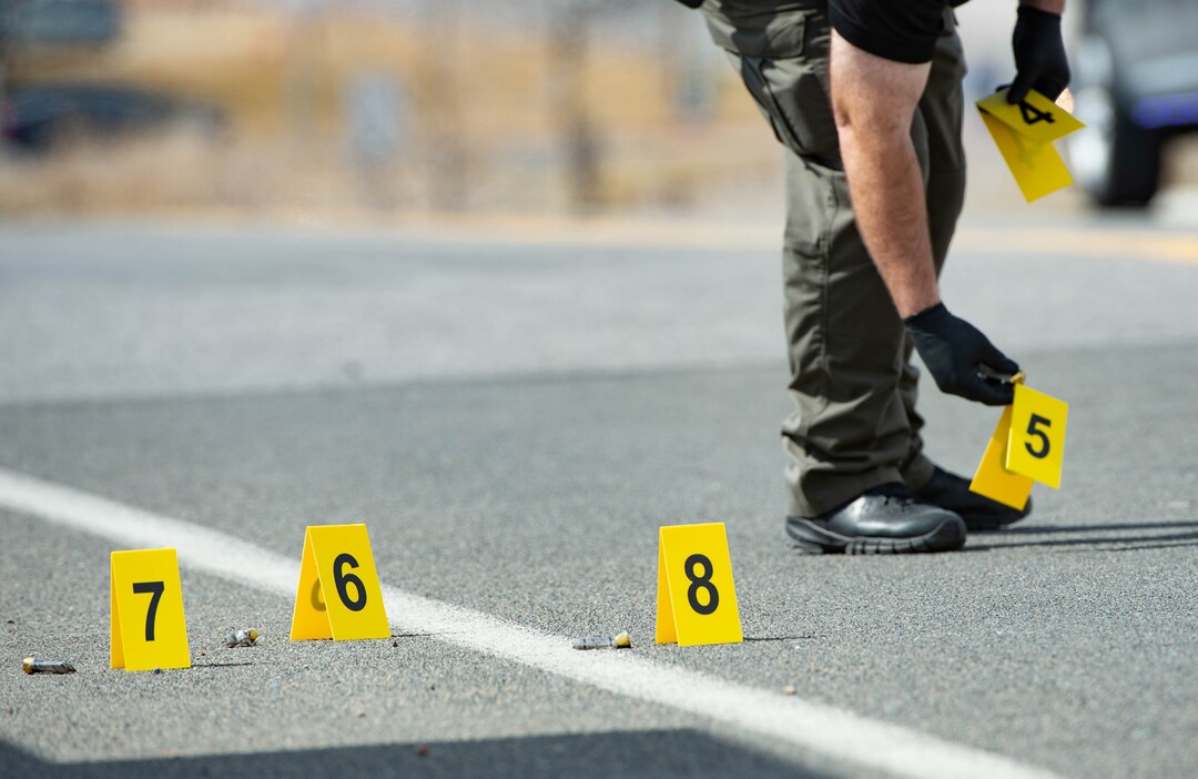 (Francisco Kjolseth  | The Salt Lake Tribune) Investigators remove evidence markers as numerous police agencies respond to a man driving erratically and claiming to have a gun and a bomb with an initial police chase ending on Center Street over Legacy Highway on Wednesday, March 17, 2021.