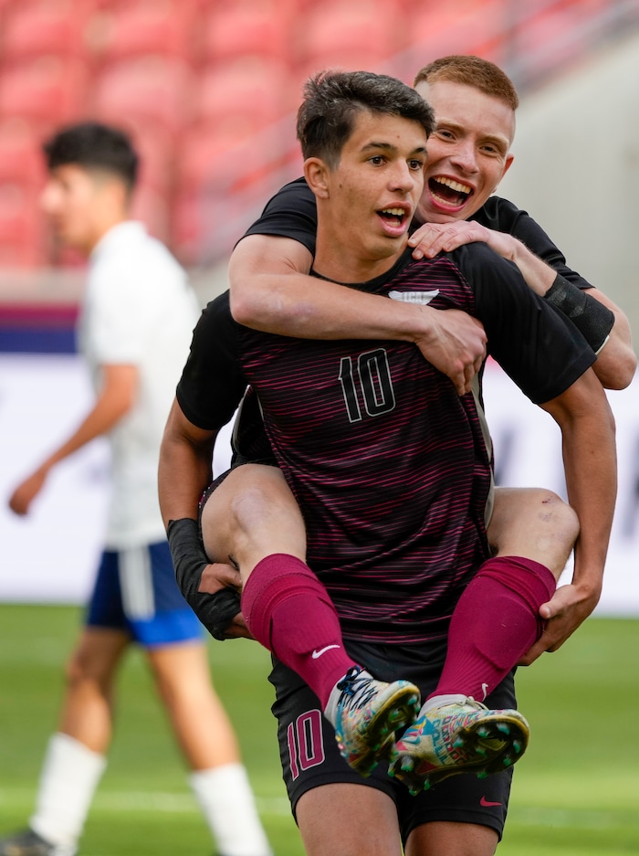 (Leah Hogsten | The Salt Lake Tribune) Layton Christian Academy's Roberto Neto leaps onto the back of Enzo Jaques after Jaques' hat trick to win for the 3A State Soccer Championship title at Rio Tinto Stadium, Wednesday, May 11, 2022. Layton Christian Academy defeated Real Salt Lake Academy 4-0. 