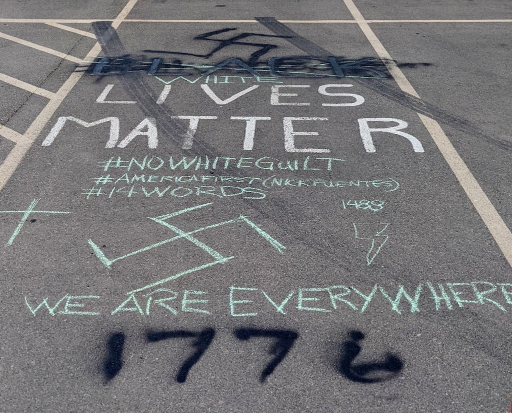 (Chris McGinty | The Herald Journal) Nazi symbols and slogans are seen in graffiti covering a Black Lives Matter message in the Logan High parking lot in July 2021. Three weeks after graffiti laden with Nazi symbols, codes and slogans appeared in a Logan High School parking lot, the local police investigation appears to have stalled.