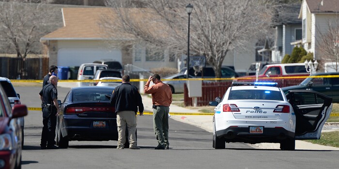 (Francisco Kjolseth | The Salt Lake Tribune) Investigators comb the scene where a Granite School District police officer shot a driver on Tuesday afternoon, March 20, 2018. While on patrol near Hunter High School, the officer noticed a car full of teenagers and smelled marijuana. When he approached the car lurched and he ended up on the hood. The driver was shot and four other teens in the car fled the scene.
