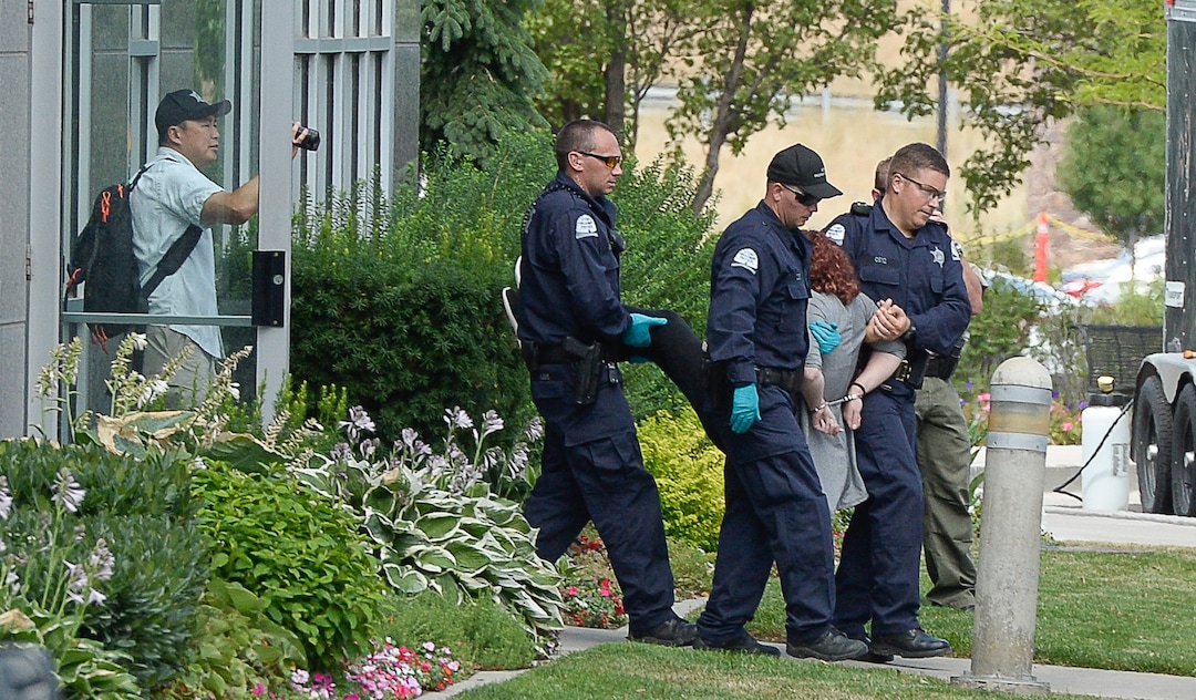(Francisco Kjolseth  |  The Salt Lake Tribune)  Activists are removed from a building where they staged a protest against a private prison company with contracts to hold undocumented immigrants on Thursday, July 12, 2018, at the headquarters of Management and Training Corporation in Centerville.