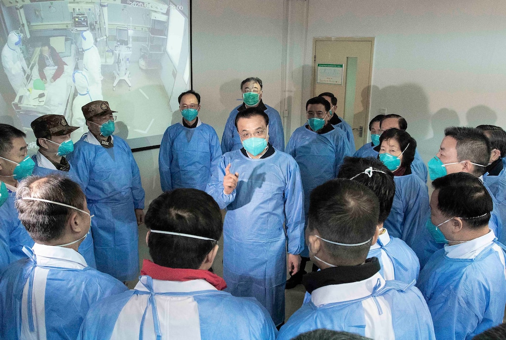 (Li Tao | Xinhua via AP) Chinese Premier Li Keqiang, center, speaks with medical workers at Wuhan Jinyintan Hospital in Wuhan in central China's Hubei province, Monday, Jan. 27, 2020. China on Monday expanded its sweeping efforts to contain a deadly virus, extending the Lunar New Year holiday to keep the public at home and avoid spreading infection.
