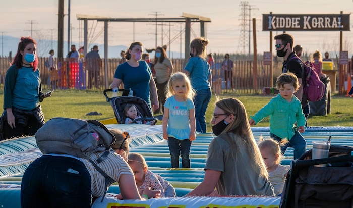 (Leah Hogsten | The Salt Lake Tribune)  A young tot looks to her mother for attention during the Baby Animal Festival and Tulip Field Festival at Cross E Ranch, April 23, 2021. The festival runs unlil May 8.
