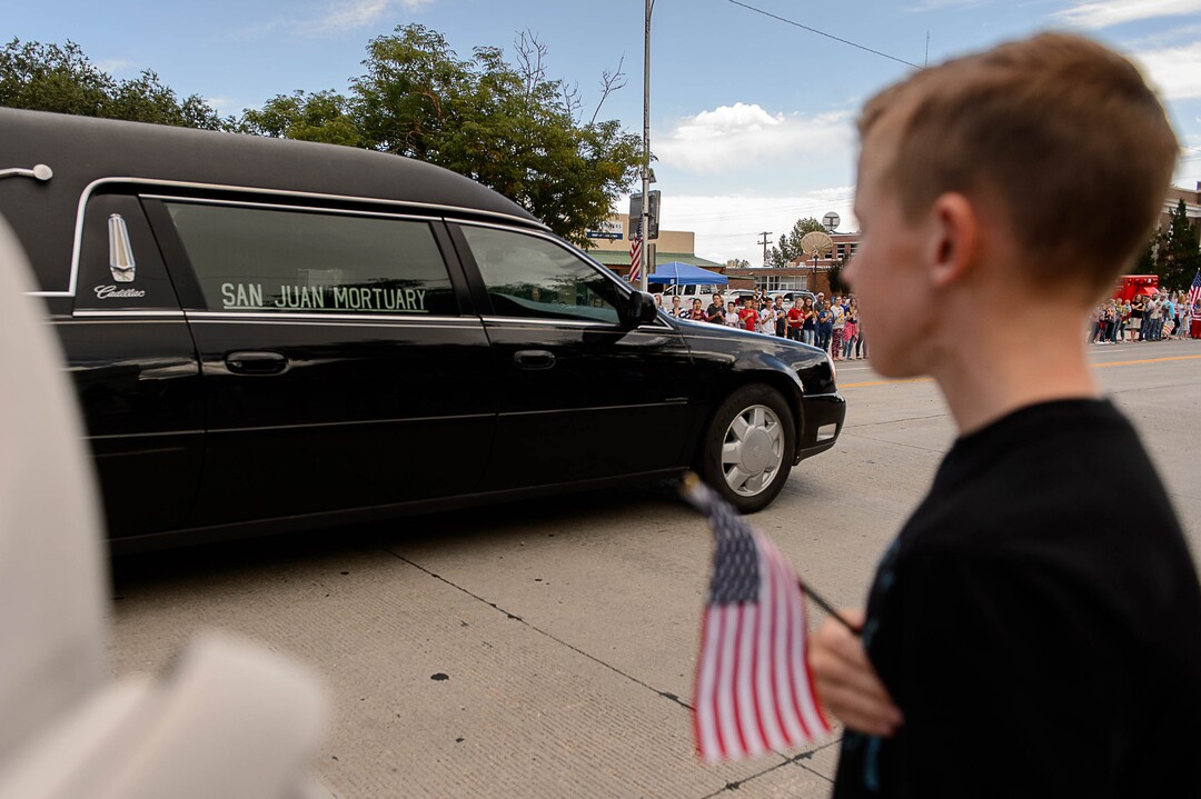 (Trent Nelson | The Salt Lake Tribune)  Crowds line Main Street in Monticello to honor the motorcade of fallen soldier Aaron Butler, who was killed last week in Afghanistan, , Thursday August 24, 2017.