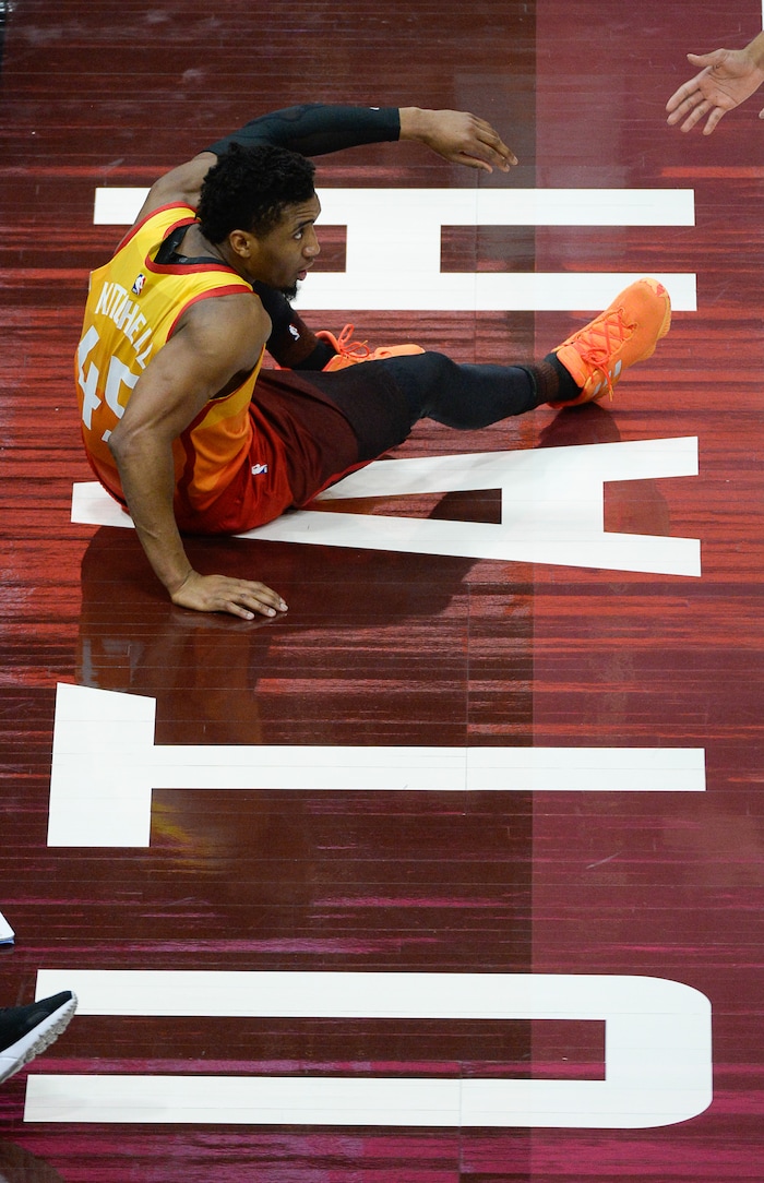 (Francisco Kjolseth  |  The Salt Lake Tribune)   Utah Jazz guard Donovan Mitchell (45) slides off the court against the Thunder in the NBA game at Vivint Smart Home Arena Sat., Dec. 22, 2018, in Salt Lake City.