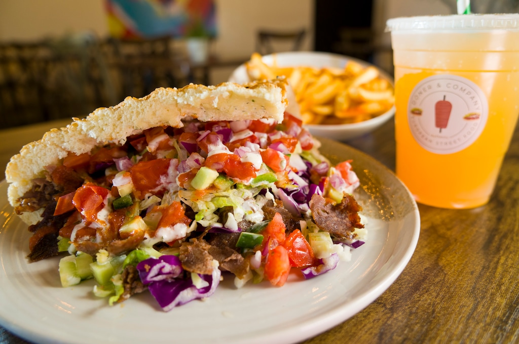 (Bethany Baker | The Salt Lake Tribune) A beef döner with fries and a passionfruit schorle drink sit on a table at Döner & Company, a new restaurant in the Central Ninth neighborhood in Salt Lake City.