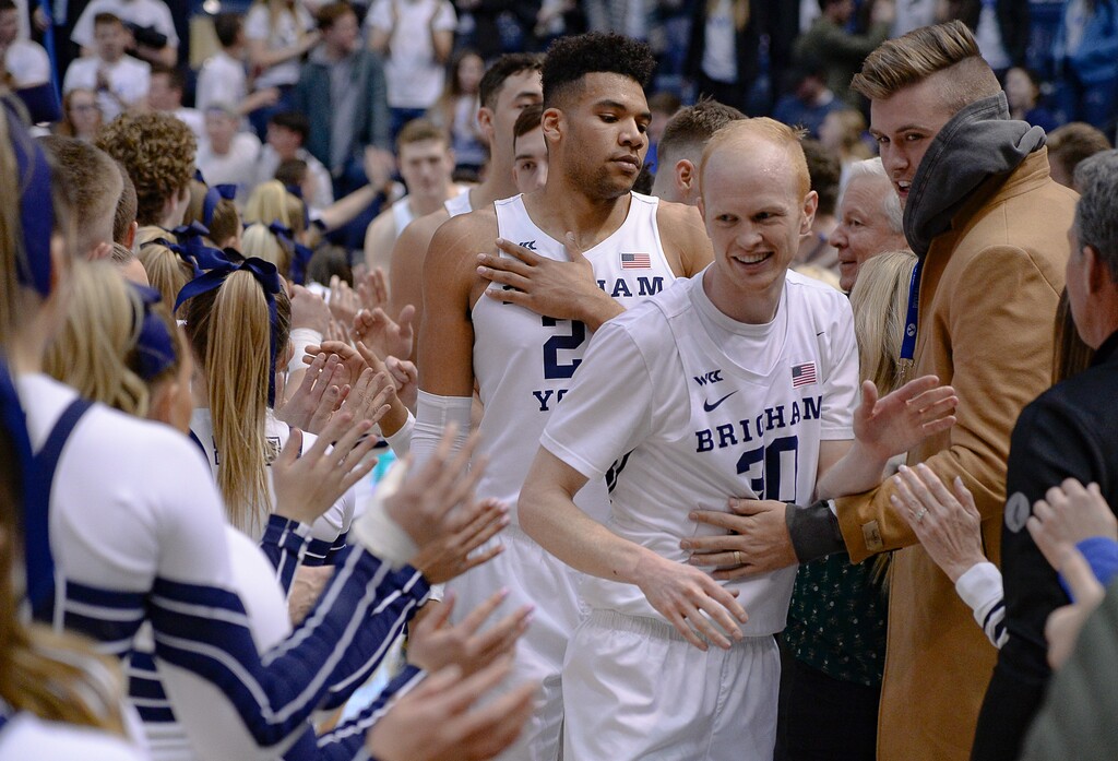 (Francisco Kjolseth | The Salt Lake Tribune) Brigham Young Cougars forward Yoeli Childs (23) and Brigham Young Cougars guard TJ Haws (30) are celebrated following their 85-75 win over the Santa Clara Broncos at the Marriott Center in Provo, Thursday, Feb. 20, 2020.