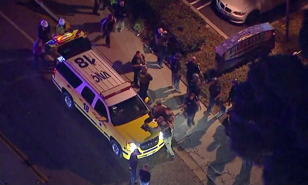 This image made from aerial video show officers around a Police SUV in the vicinity of a shooting in Thousand Oaks, California, early Thursday, Nov. 8, 2018. Authorities say there were multiple injuries - including one officer - after a man opened fire in Southern California bar late Wednesday. (KABC via AP)