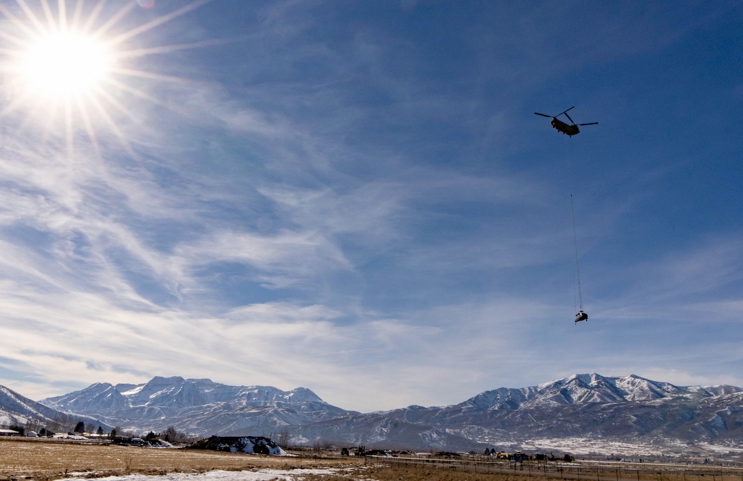 (Francisco Kjolseth | The Salt Lake Tribune) Recovery operations for two Utah Army National Guard UH-60 Black Hawk helicopters involved in a training accident in the Mineral Basin area last week are performed by a CH-47 Chinook helicopter and brought to the Heber Valley Airport on Wednesday, March 2, 2022.