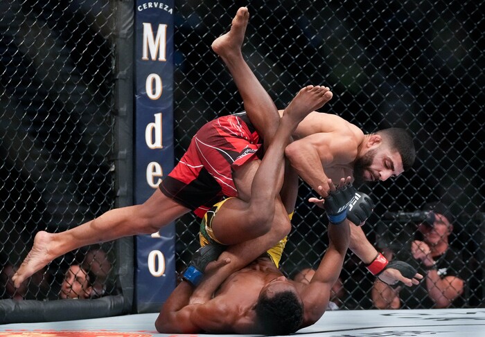 (Francisco Kjolseth | The Salt Lake Tribune) Amir Albazi of Iraq gets over Francisco Figueiredo of Brazil during their UFC 278 flyweight bout at Vivint Arena on Saturday, Aug. 20, 2022. 