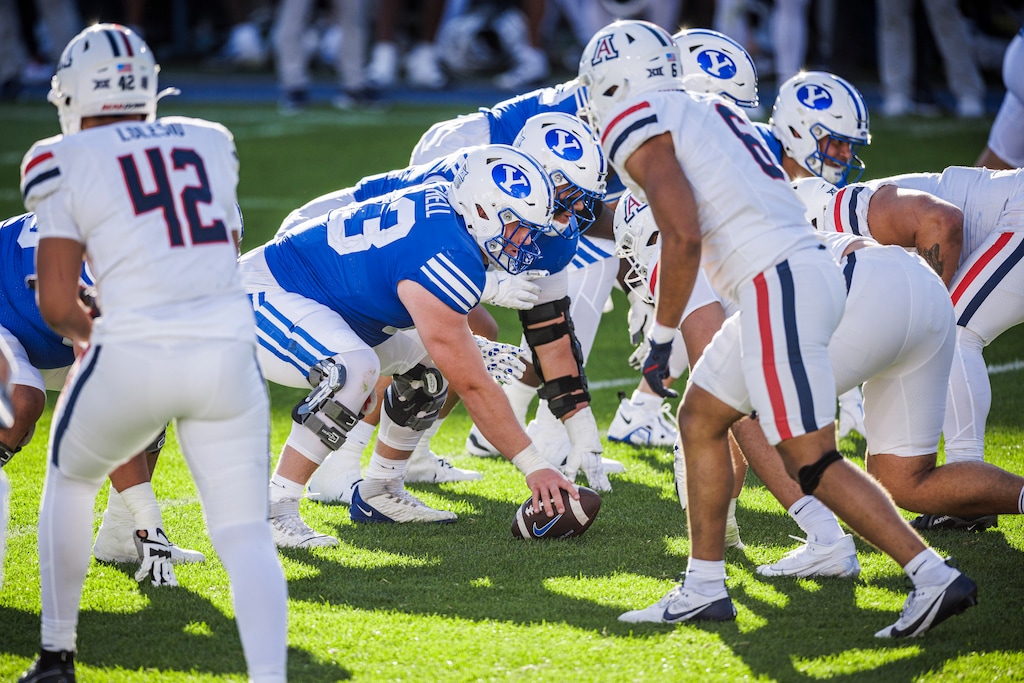 (Matt Norton | BYU) Bruce Mitchell snaps the ball to Jake Retzlaff on October 12, 2024.