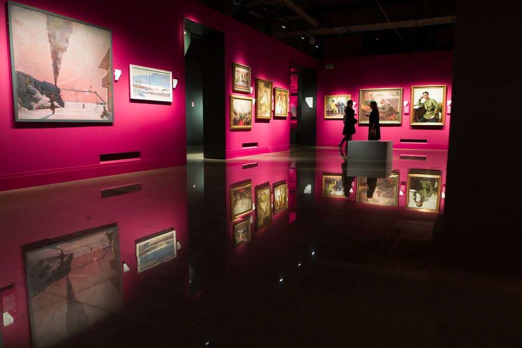 In this photo taken on Thursday, March 16, 2017, Georgy Nissky's "En Route," left, is on display in the Institute of Russian Realist Art, a private museum in Moscow, Russia. A sale of Soviet-era masterpieces at auction in London in 2014, one selling for $2 million, has triggered a criminal investigation in Russia and a push to re-nationalize the collection that once belonged to a Soviet artists' trade union. (AP Photo/Alexander Zemlianichenko)