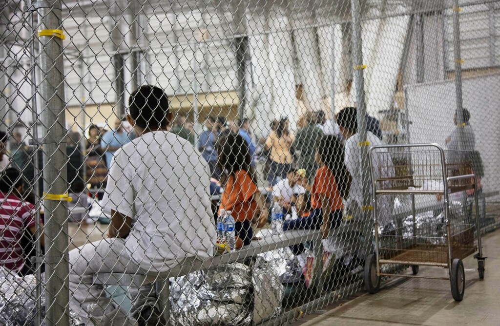 (U.S. Customs and Border Protection's Rio Grande Valley Sector | The Associated Press) In this photo provided by U.S. Customs and Border Protection, people who've been taken into custody related to cases of illegal entry into the United States, sit in one of the cages at a facility in McAllen, Texas, Sunday, June 17, 2018. More than 2,300 minors have been separated from their parents since April, when the Trump administration launched its "zero-tolerance" policy that called for prosecuting illegal immigrants and taking their children away.