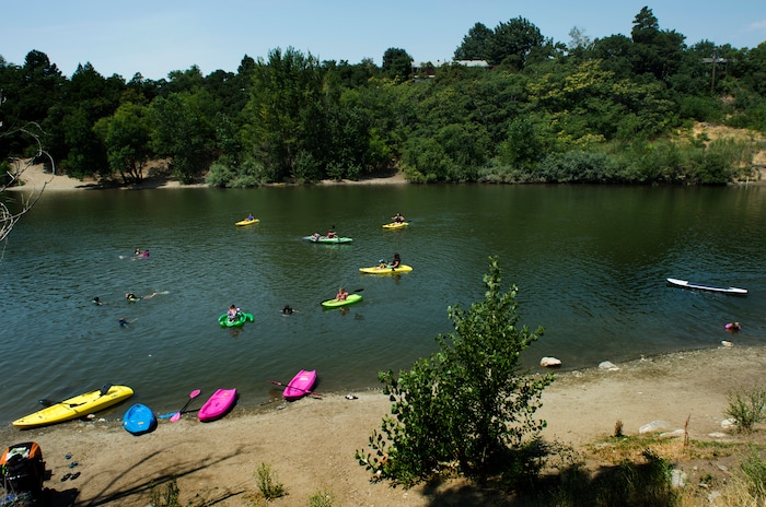 (Rick Egan  |  The Salt Lake Tribune)    Kids swim and kayak to beat the heat, as they float on Farmington Pond, Thursday, July 26, 2018.