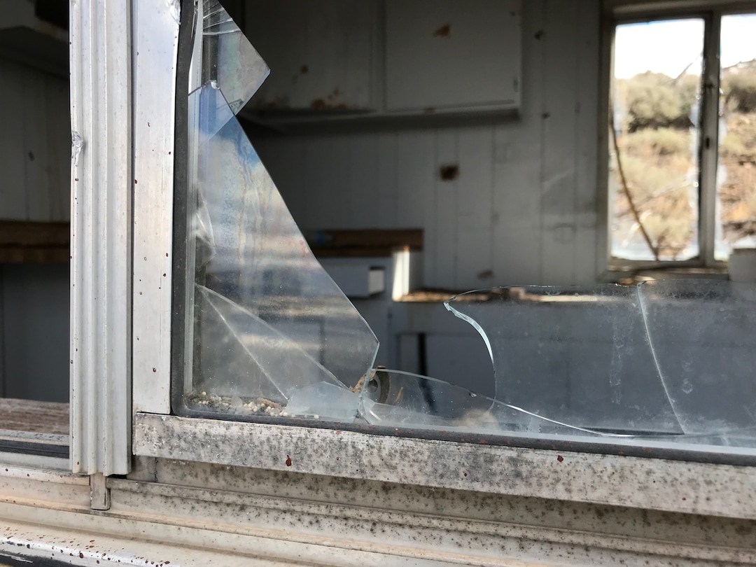 (Paighten Harkins | The Salt Lake Tribune) Broken glass in a window pane of a small building near a mine outside Eureka. Searchers looked through the building Feb. 10, 2018, while searching for Riley Powell and Breezy Otteson.