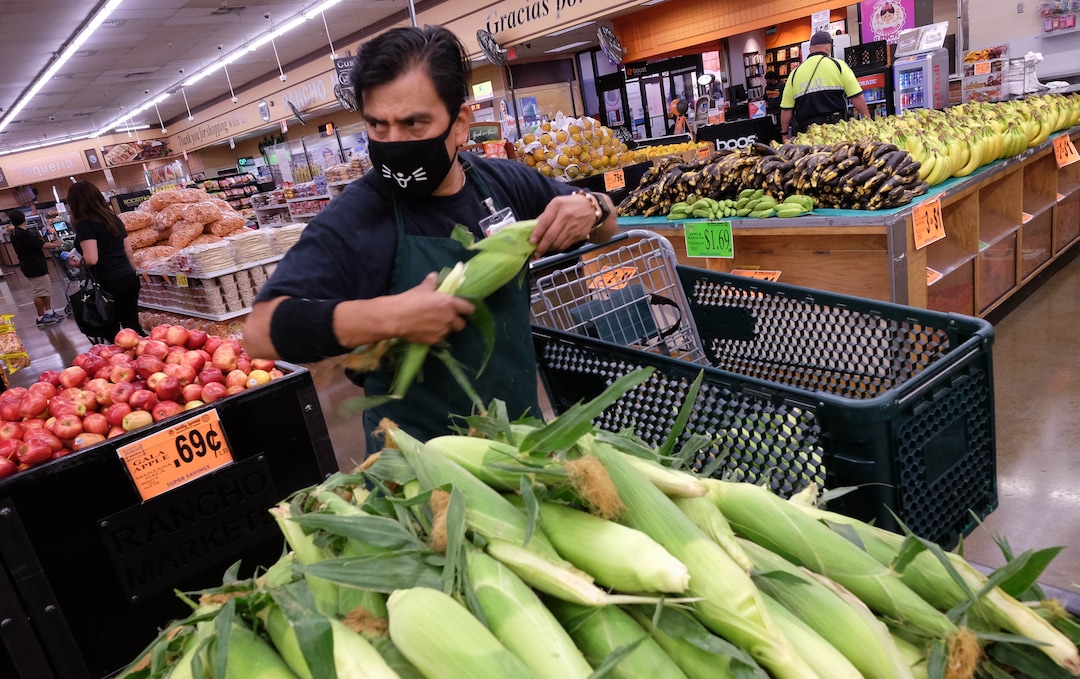 (Francisco Kjolseth  |  The Salt Lake Tribune) Diego Duarte wears a mask as he stocks produce at Rancho Markets which has implemented numerous safety precautions at their stores to navigate the coronavirus pandemic as people shop at the 140 N. 900 West location in Salt Lake City on Friday, August 14, 2020.
