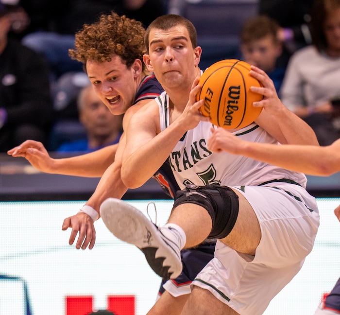 (Rick Egan | The Salt Lake Tribune) 
Olympus Titan, center, Jack Wistrcill (15) grabs a pass, as Woods Cross forward Nic Hogan (34) defends, in the 5A State Championship game between Woods Cross and Olympus, at the Marriott Center in Provo, on Saturday, March 5, 2022. 