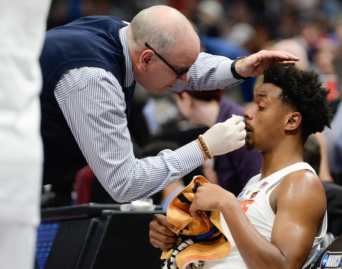 (Francisco Kjolseth  |  The Salt Lake Tribune)  Syracuse Orange forward Elijah Hughes (33) is treated for a bloody nose as Syracuse faces Baylor in their first round menÕs NCAA March Madness tournament game at Vivint Smart Home Arena in Salt Lake City on Thursday, March 21, 2019.