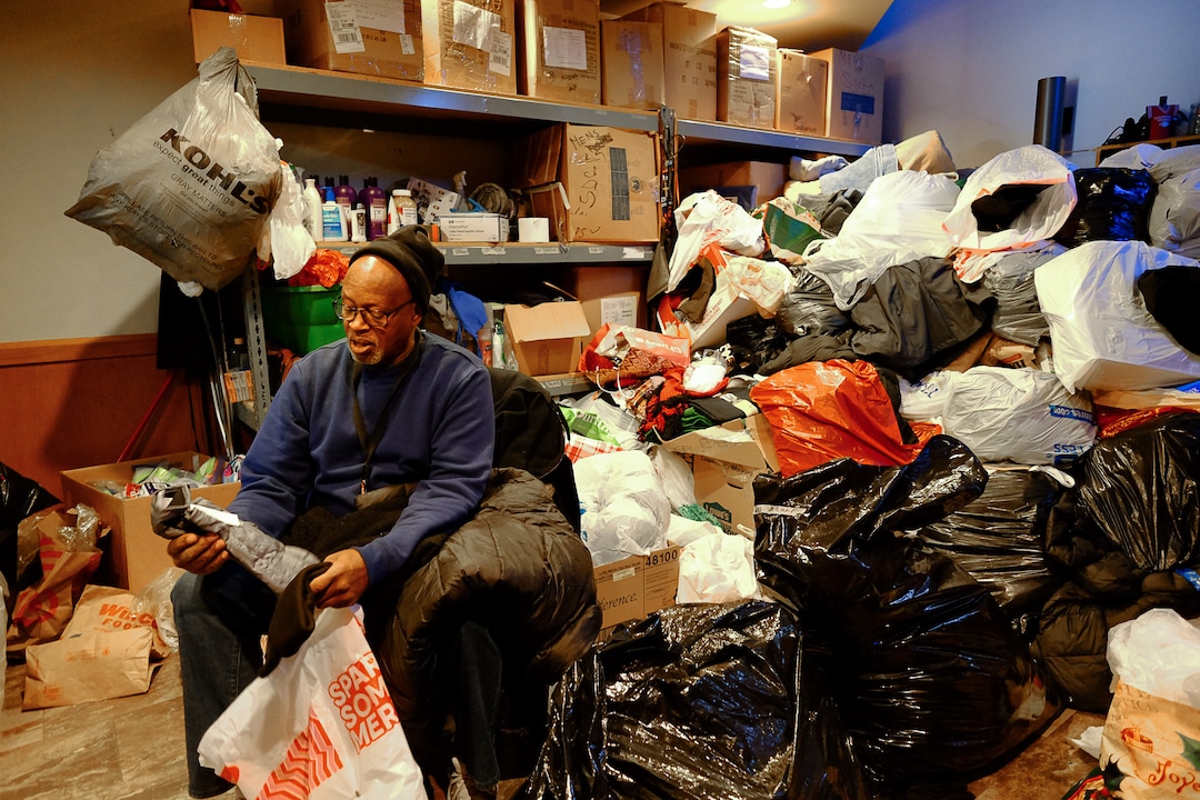 (Francisco Kjolseth  |  The Salt Lake Tribune) William Pinkey who has worked for St. Vincent de Paul's Catholic Community Services for 19 years, sorts through holiday donations recently on Wednesday, Dec. 18, 2019.