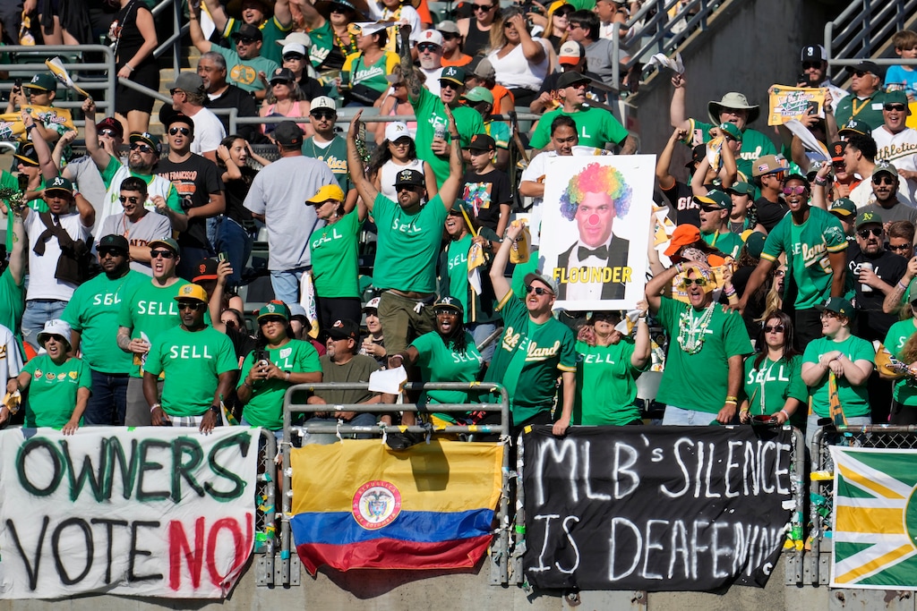 (Jeff Chiu | AP) Oakland Athletics fans in right field yell behind signs protesting the team's potential move to Las Vegas and to call for management to sell the team during the fifth inning of a baseball game between the Athletics and the San Francisco Giants in Oakland, Calif., Aug. 5, 2023.