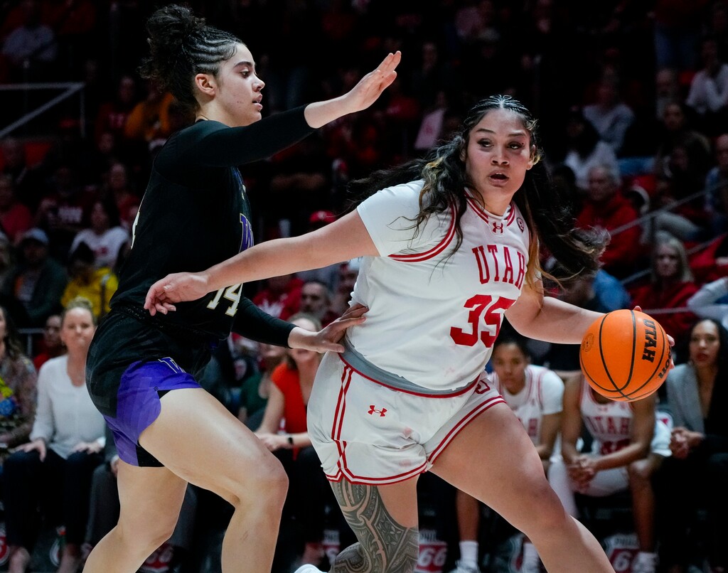 (Bethany Baker  |  The Salt Lake Tribune) Utah Utes forward Alissa Pili (35) dribbles around Washington Huskies forward Dalayah Daniels (14) at Jon M. Huntsman Center in Salt Lake City on Saturday, March 2, 2024.