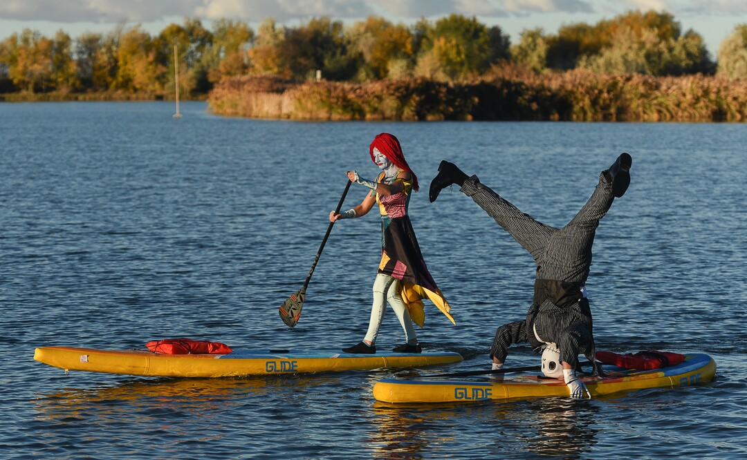 (Francisco Kjolseth  |  The Salt Lake Tribune)  Stand up paddle board enthusiasts Roxy Christensen and Chris Knoles take to the water at Bountiful Pond on Tuesday, Oct. 30, 2018, in what has become a Halloween tradition for the 4th year in a row as they dress up this year as Jack and Sally Skellington from the movie Nightmare Before Christmas. "We paddle year round but actually paddle more in the winter," exclaimed Knoles, who carry the tradition on at Christmas, dressing up in something festive and paddling on the Great Salt Lake where the high salinity usually keeps the water from freezing.