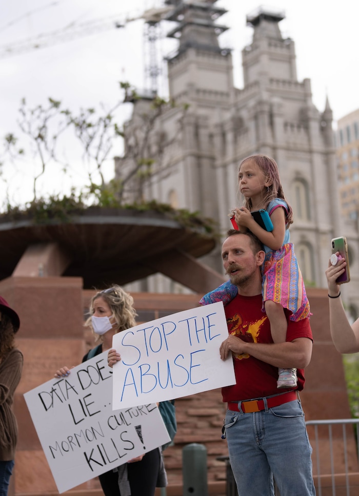 (Francisco Kjolseth | The Salt Lake Tribune) Kristen Larsen, left, and Sapakis Platt with his daughter Ellie, 6, protest on Friday, May 7, 2021, to petition the First Presidency to repeal the excommunication of Natasha Helfer, a sex therapist who lost her membership in The Church of Jesus Christ of Latter-day Saints.