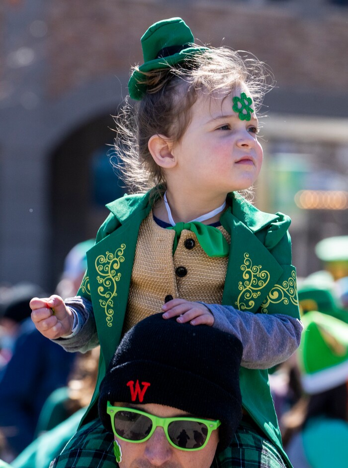 (Rick Egan | The Salt Lake Tribune) Iris Vargas, 3  watch the St. Patrick's parade on the shoulders of her dad, Max Vargas, in Salt Lake City, on Saturday, March 12, 2022.