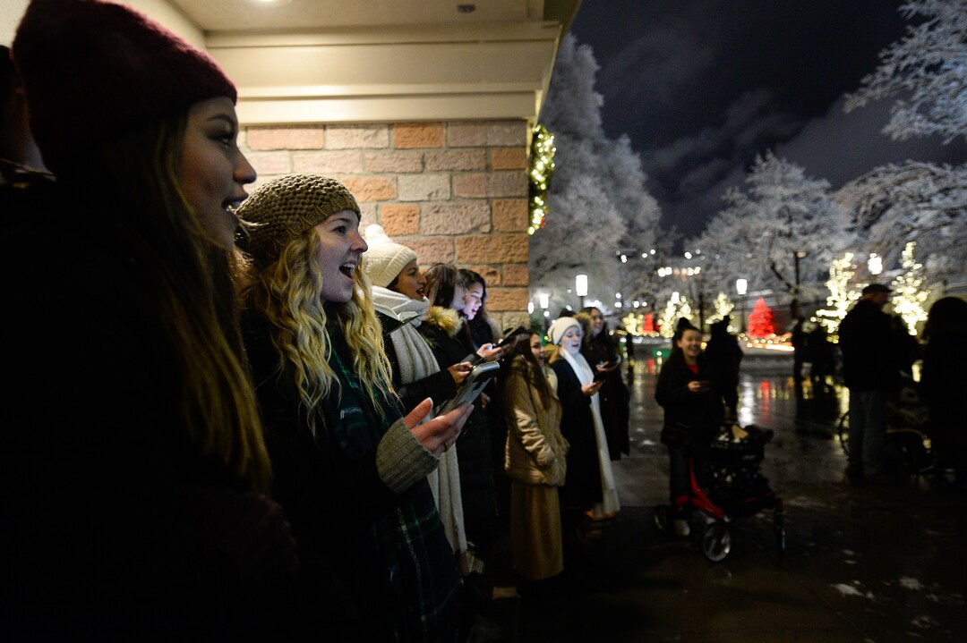 (Francisco Kjolseth  |  The Salt Lake Tribune)  Visitors take in the sights and sounds of carolers as Temple Square in Salt Lake City comes to life Friday, November 29, 2019, as hundreds of thousands of colorful LED bulbs light up, a yearly tradition that started in 1965. The lights will run through the end of the year.