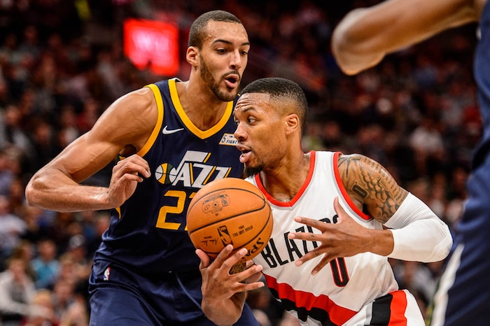 (Trent Nelson | The Salt Lake Tribune)  Portland Trail Blazers guard Damian Lillard (0) drives on Utah Jazz center Rudy Gobert (27) as the Utah Jazz host the Portland Trail Blazers, NBA basketball in Salt Lake City, Wednesday November 1, 2017.