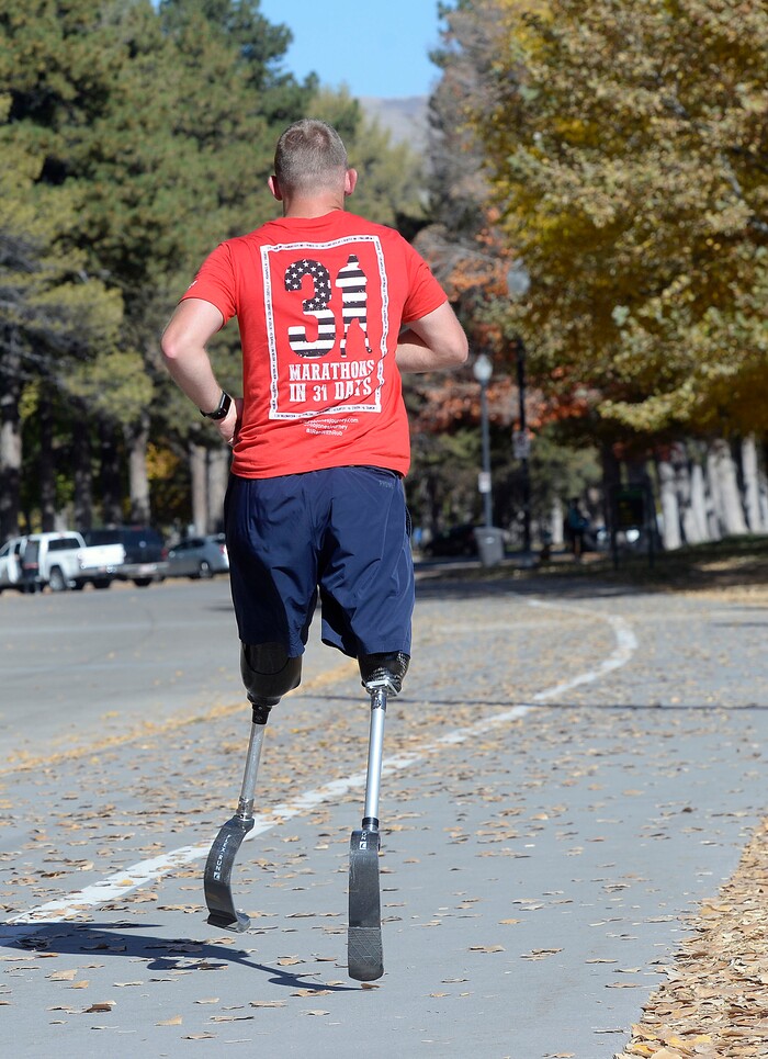 Al Hartmann | The Salt Lake Tribune)
Rob Jones, a retired Marine Corps Sergeant who lost both legs when he stepped on an improvised explosive device in Afghanistan, runs a marathon, (26.2) miles in Liberty Park in Salt Lake City Wednesday Oct. 25. He won a Bronze Medal in the Paralympics and he wis the first and only double above the knee amputee to ride a normal bicycle 5,180 miles across America. Now, he is set to run 31 marathons in 31 days in 31 major cities. Starting in London on October 12th, and continuing in the United States and Toronto, he will run 26.2 miles in the selected city on his own, travel to the next city, and repeat, ending appropriately on Veterans Day in our Nation’s Capital. His motto, “Survive. Recover. Live.”