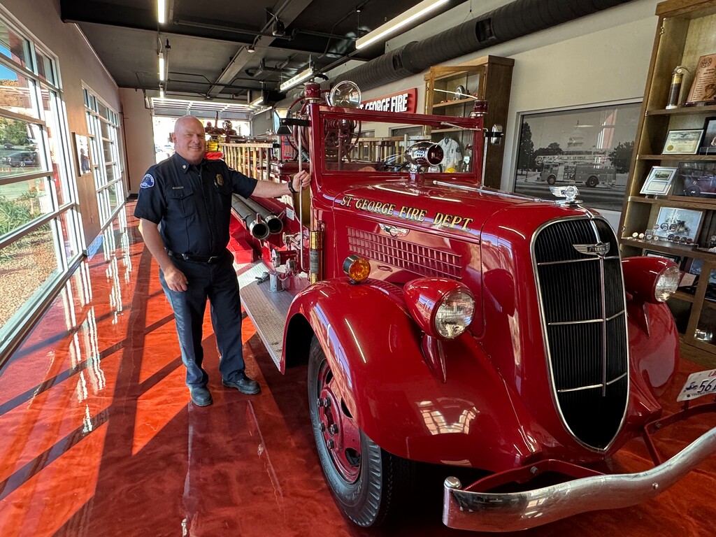 (Mark Eddington | The Salt Lake Tribune) St. George Fire Chief Robert Stoker poses next to the department's first engine, a 1936 Studebaker, at Fire Station 1 in St. George, Friday, Nov. 7, 2025.