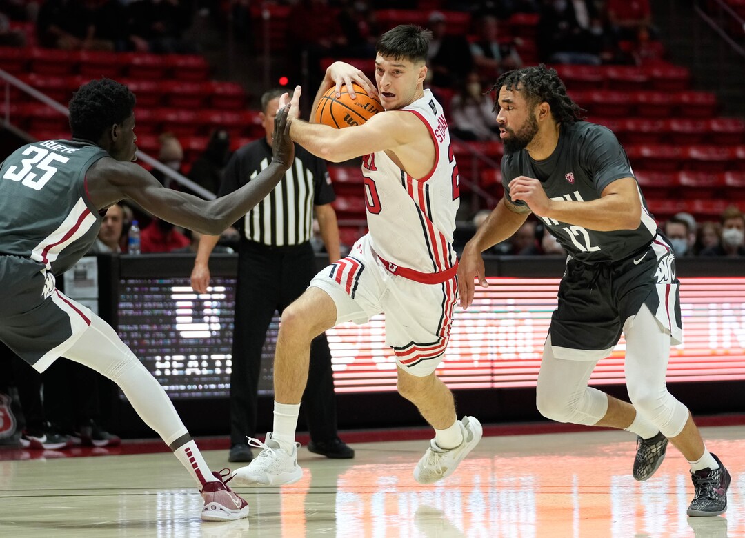 (Francisco Kjolseth | The Salt Lake Tribune) Washington State Cougars forward Mouhamed Gueye (35) and Washington State Cougars guard Michael Flowers (12) try to cut off the advancement of Utah Utes guard Lazar Stefanovic (20) in game action during an NCAA college basketball game at the Jon M.Huntsman Center, on Saturday, Jan. 8, 2022. Utah lost 61-77.