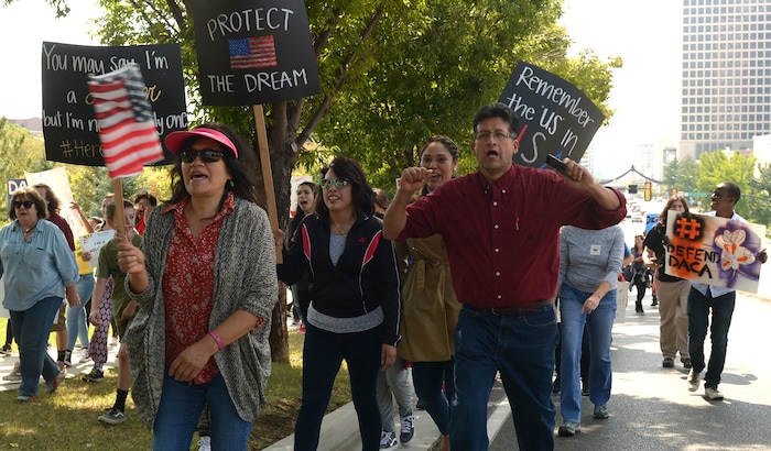 (Leah Hogsten  |  The Salt Lake Tribune) Adan Bravo, right, and his wife Ruth, left, from Orem march with DACA supporters. Hundreds of "We are Dreamers," a Utah pro-Deferred Action for Childhood Arrival (DACA) group, marched in solidarity from the Utah Federal Building to the State Capitol with undocumented immigrants who will be affected by the end of DACA.