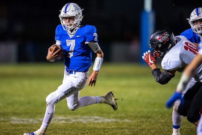 (Chris Detrick  |  The Salt Lake Tribune)  Fremont's Dawson Sanford (7) runs past Weber's Ben Pobanz (10) during the game at Fremont High School Thursday, October 5, 2017. 