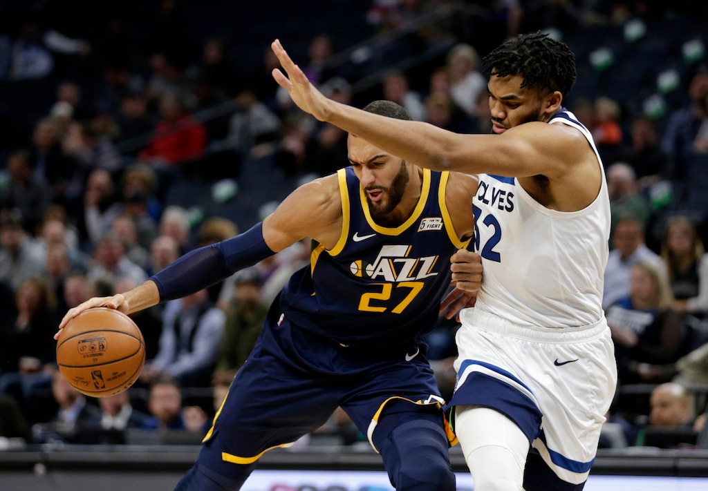 Utah Jazz center Rudy Gobert (27) drives on Minnesota Timberwolves center Karl-Anthony Towns (32) during the first quarter of an NBA basketball game Wednesday, Nov. 20, 2019, in Minneapolis. (AP Photo/Andy Clayton- King)