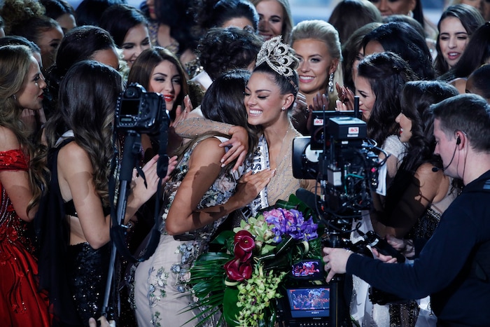 (John Locher | The Associated Press) Contestants congratulate new Miss Universe Demi-Leigh Nel-Peters at the Miss Universe pageant Sunday, Nov. 26, 2017, in Las Vegas.